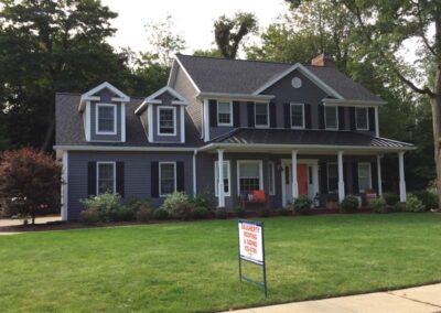 Home with a standing seam metal roof over the large front porch and Certainteed shingles covering the rest of the house. Installed by Daugherty Roofing 814.