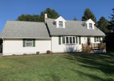 Shown: Cape Cod home with added garage and new roof in McKean, PA.