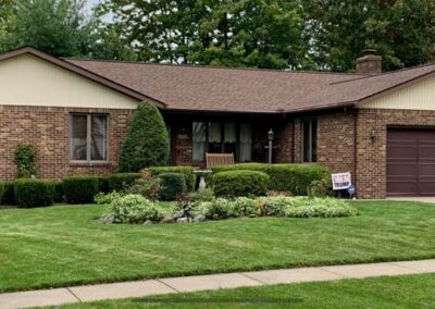 Updated contemporary L-shaped brick ranch with new roof in West Millcreek, PA. Roof provided and installed by Daugherty Roofing 814.