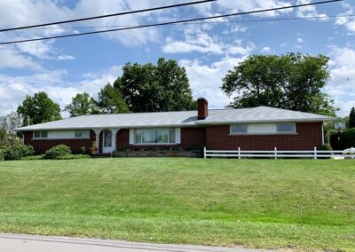 Home in Harbor Creek, PA with traditional brick exterior and new roof installed by Daugherty Roofing 814 is shown here.